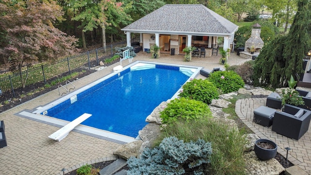 2443 Shepherd Ct, Powell, OH 43065 - view of swimming pool featuring fence, a patio area, an exterior structure, an outdoor structure, and a diving board