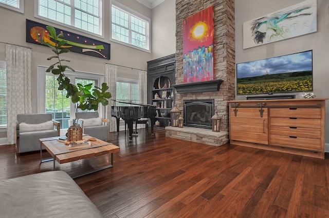 2443 Shepherd Ct, Powell, OH 43065 - living area featuring a high ceiling, wood finished floors, healthy amount of natural light, a fireplace, and ornamental molding