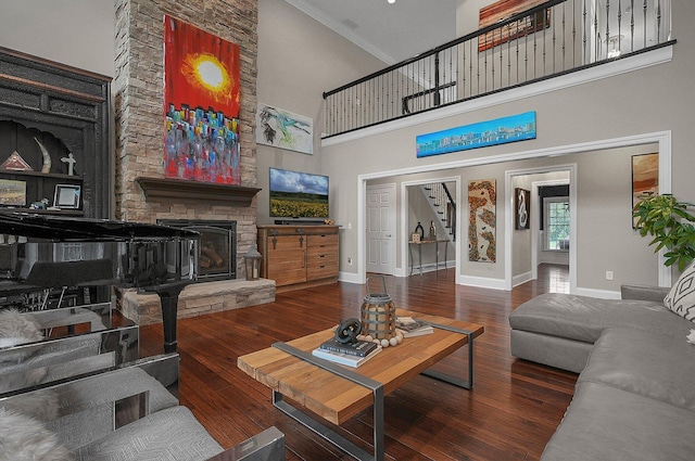 2443 Shepherd Ct, Powell, OH 43065 - living area featuring a towering ceiling, baseboards, hardwood / wood-style flooring, and a stone fireplace
