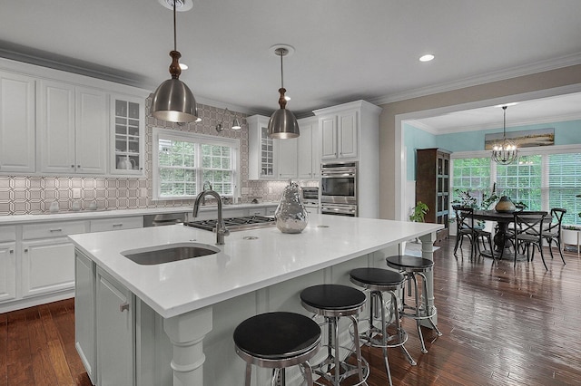 2443 Shepherd Ct, Powell, OH 43065 - kitchen featuring a sink, white cabinets, double oven, glass insert cabinets, and ornamental molding