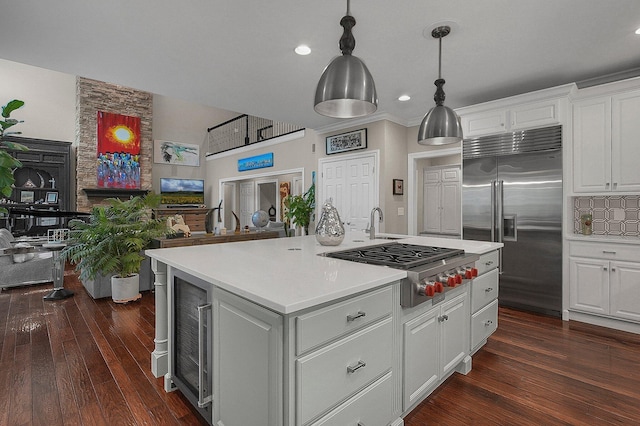 2443 Shepherd Ct, Powell, OH 43065 - kitchen featuring appliances with stainless steel finishes, open floor plan, light countertops, white cabinets, and recessed lighting
