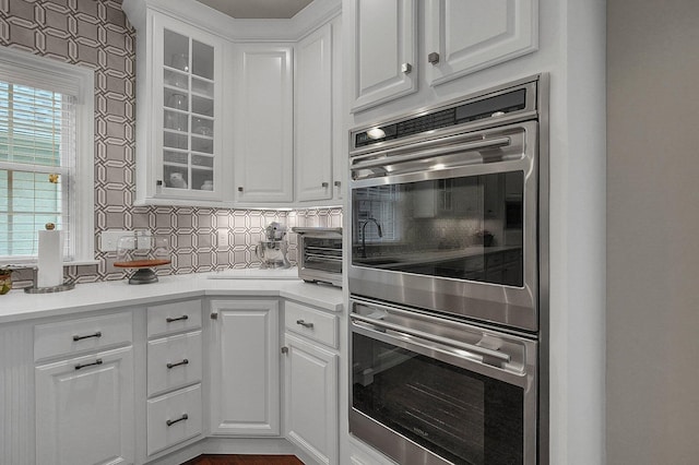 2443 Shepherd Ct, Powell, OH 43065 - kitchen with double oven, white cabinets, glass insert cabinets, and decorative backsplash