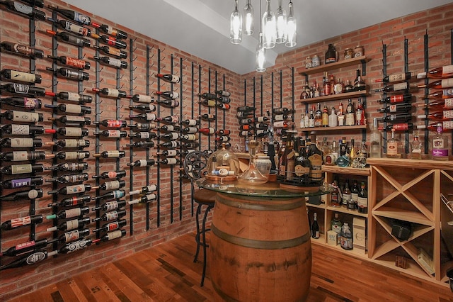 2443 Shepherd Ct, Powell, OH 43065 - wine room with wood finished floors and brick wall