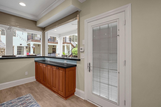 2443 Shepherd Ct, Powell, OH 43065 - bar area featuring light wood finished floors, healthy amount of natural light, baseboards, crown molding, and ornate columns