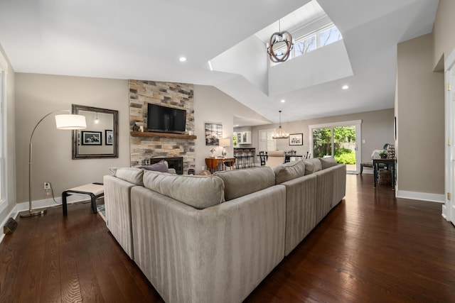 living area featuring baseboards, a fireplace, recessed lighting, and dark wood-type flooring