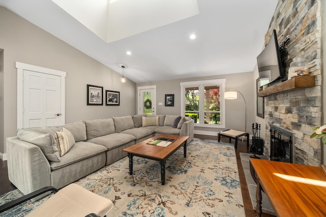 living room with a stone fireplace, wood finished floors, baseboards, high vaulted ceiling, and recessed lighting