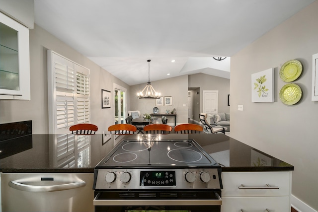 kitchen with stainless steel electric range oven, dark countertops, an inviting chandelier, white cabinetry, and vaulted ceiling