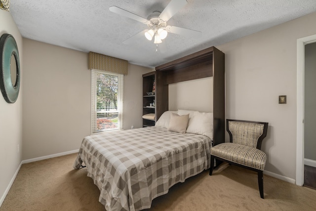 bedroom with baseboards, carpet, a ceiling fan, and a textured ceiling