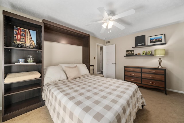 carpeted bedroom with baseboards, visible vents, and ceiling fan