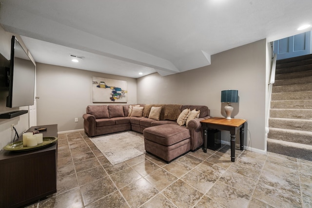 living area with stairs, baseboards, visible vents, and stone tile floors
