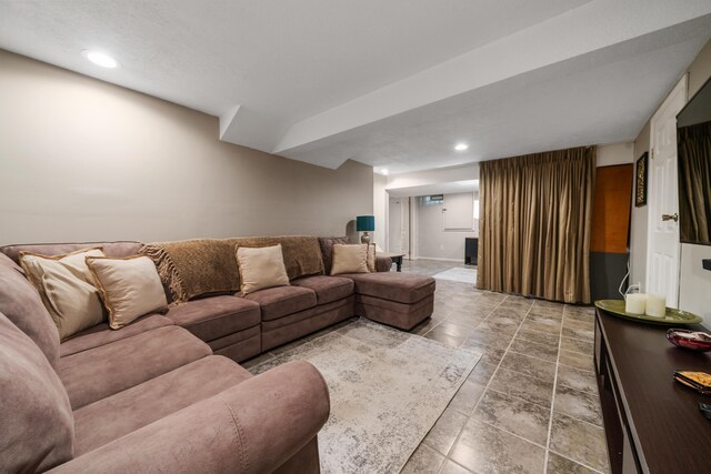 living area featuring recessed lighting and baseboards