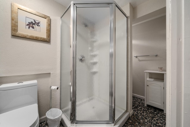 full bath featuring toilet and a stall shower