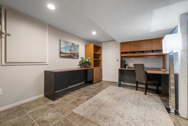 office space featuring baseboards, recessed lighting, and built in desk