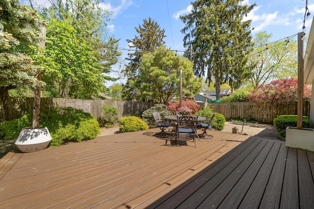 wooden deck featuring a fenced backyard and outdoor dining space