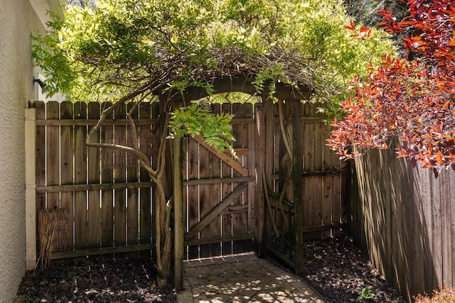 view of gate with fence