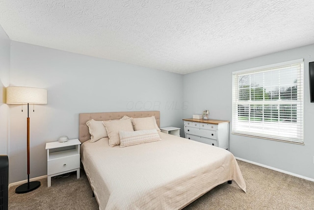 bedroom featuring a textured ceiling, carpet flooring, and baseboards