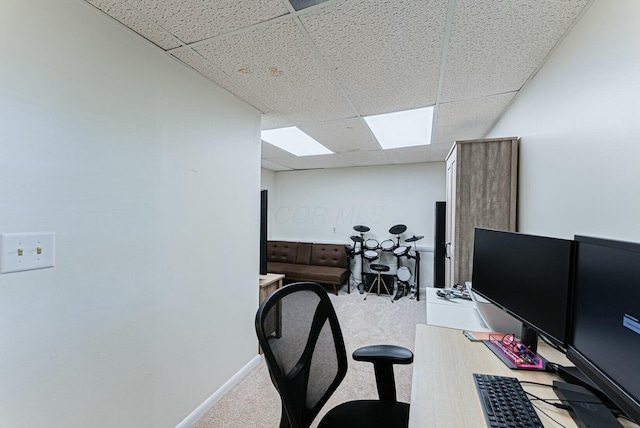 carpeted office with a paneled ceiling and baseboards