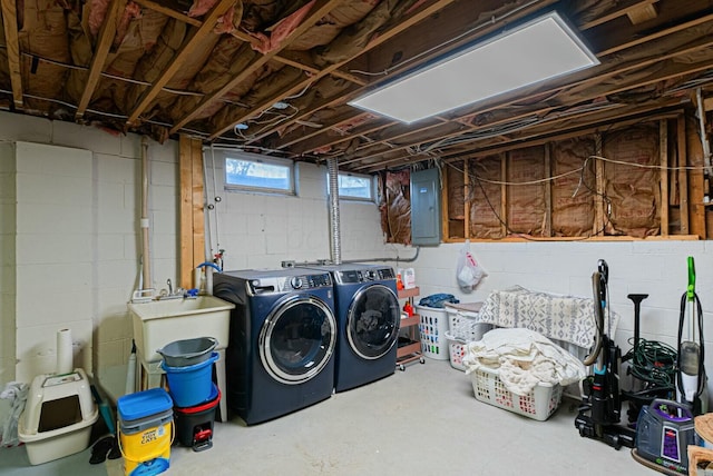 below grade area with separate washer and dryer, electric panel, and a sink