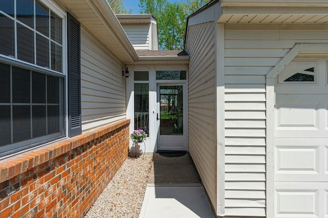 view of exterior entry with brick siding