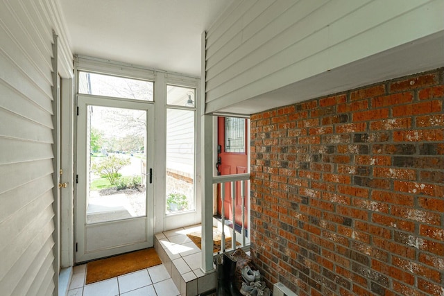 doorway with tile patterned floors and a wealth of natural light
