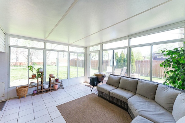 sunroom / solarium featuring tile patterned floors and an outdoor hangout area
