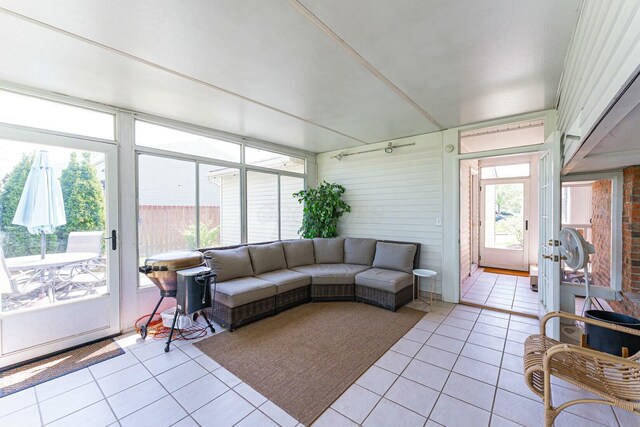 sunroom / solarium with an outdoor hangout area, tile patterned flooring, and a healthy amount of sunlight