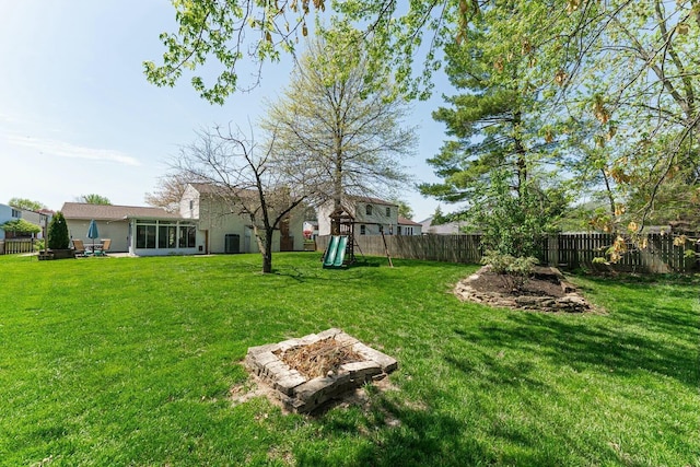 view of yard featuring a playground and a fenced backyard