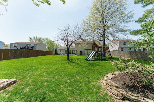 view of yard featuring a playground and a fenced backyard