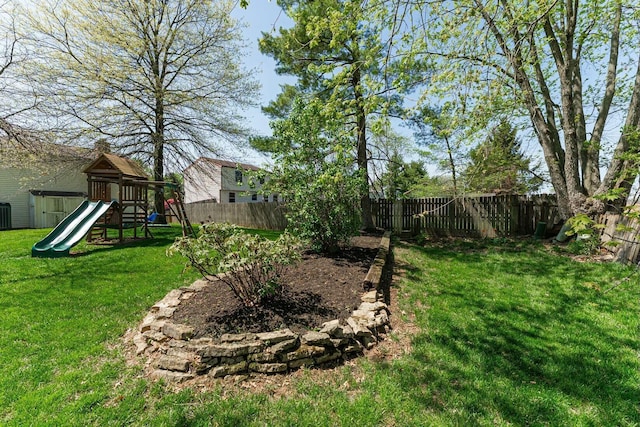 view of yard with a playground and a fenced backyard