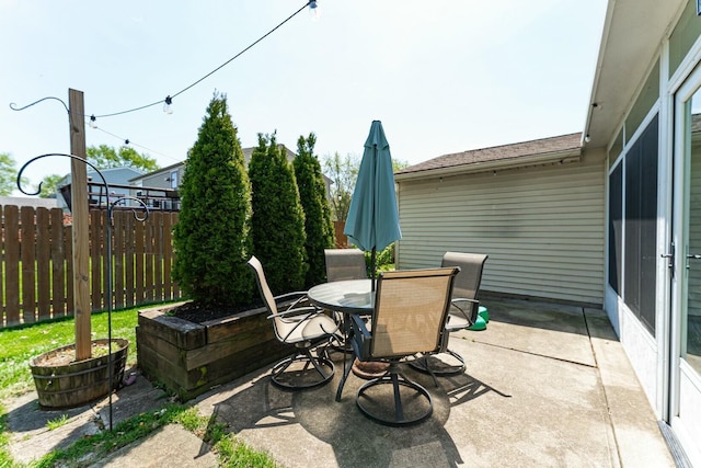view of patio / terrace featuring outdoor dining area and fence