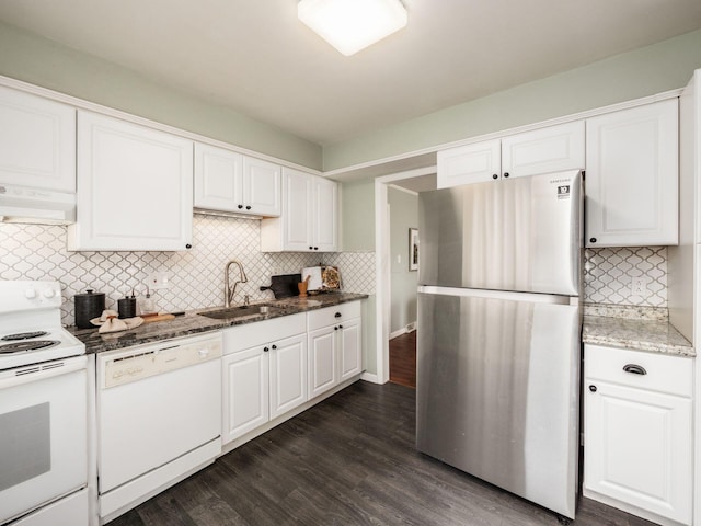 kitchen featuring tasteful backsplash, white appliances, extractor fan, and a sink