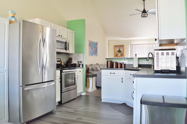 2651 Winningwillow Dr, Columbus, OH 43207 - kitchen with stainless steel appliances, a sink, lofted ceiling, dark countertops, and white cabinets