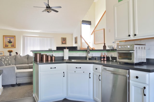 2651 Winningwillow Dr, Columbus, OH 43207 - kitchen featuring stainless steel dishwasher, dark countertops, open floor plan, a sink, and plenty of natural light
