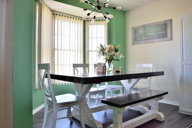 2651 Winningwillow Dr, Columbus, OH 43207 - dining area with a chandelier, baseboards, wood finished floors, and a textured ceiling