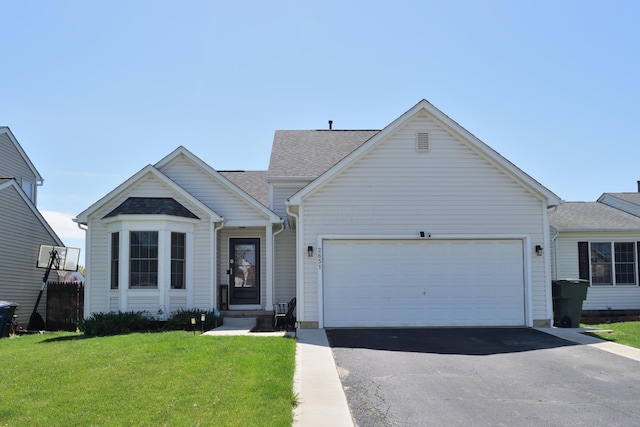 2651 Winningwillow Dr, Columbus, OH 43207 - view of front facade featuring asphalt driveway, an attached garage, a front lawn, and a shingled roof