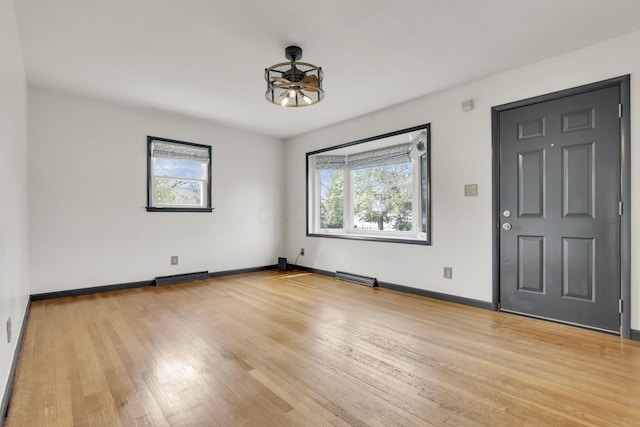 interior space featuring baseboards, visible vents, and light wood-style floors