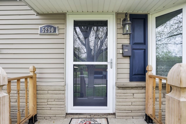 view of exterior entry with a porch