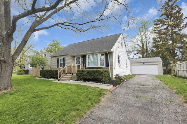 bungalow-style home with a garage, fence, a shingled roof, and a front lawn