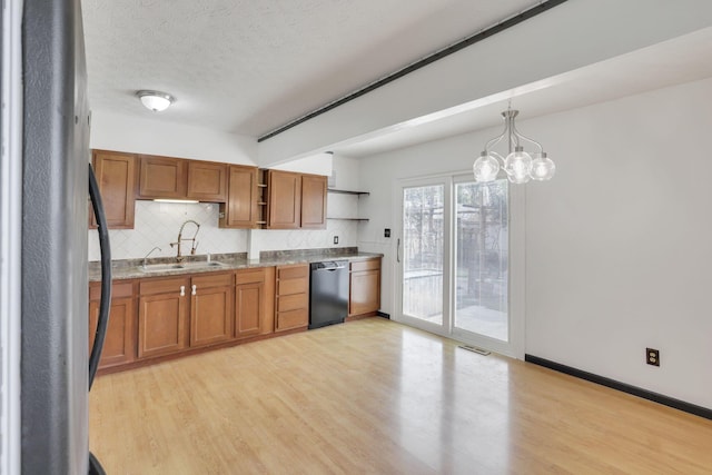 kitchen with open shelves, a sink, dishwasher, brown cabinetry, and freestanding refrigerator