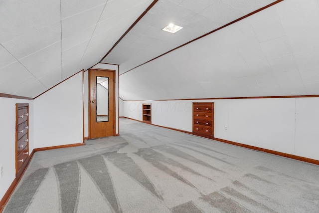 bonus room featuring carpet floors, baseboards, and vaulted ceiling