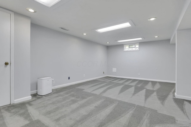 below grade area featuring carpet floors, recessed lighting, baseboards, and visible vents