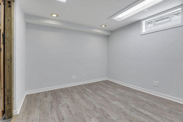 below grade area with baseboards, recessed lighting, and wood finished floors