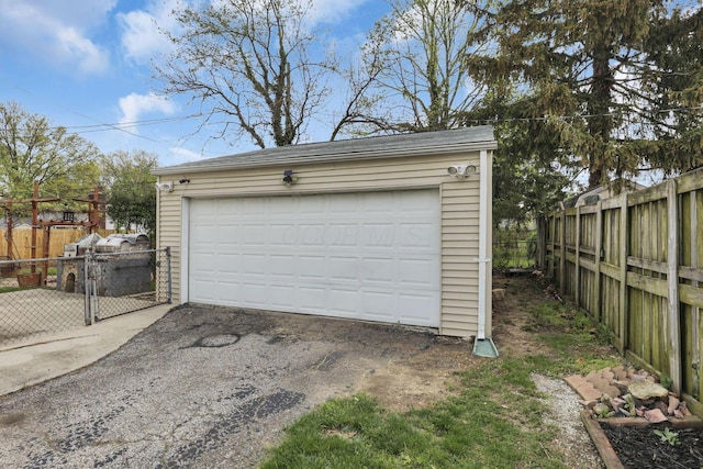 detached garage featuring fence
