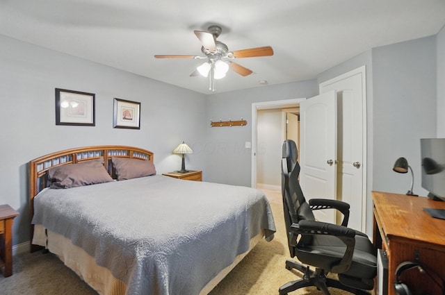 carpeted bedroom with a ceiling fan and baseboards