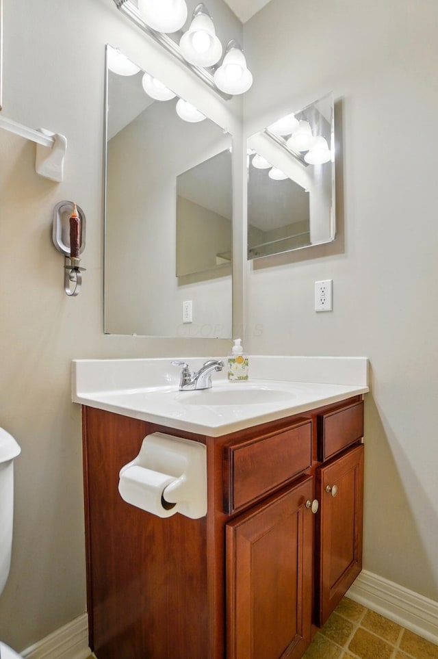bathroom with vanity and baseboards