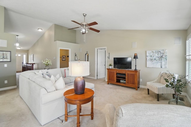living room with a ceiling fan, baseboards, light colored carpet, and high vaulted ceiling