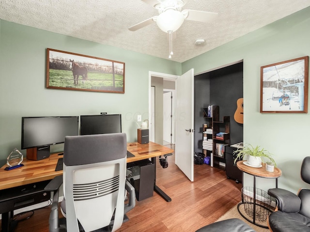 office featuring a ceiling fan, wood finished floors, and a textured ceiling