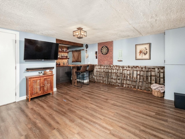 unfurnished living room with a textured ceiling and wood finished floors