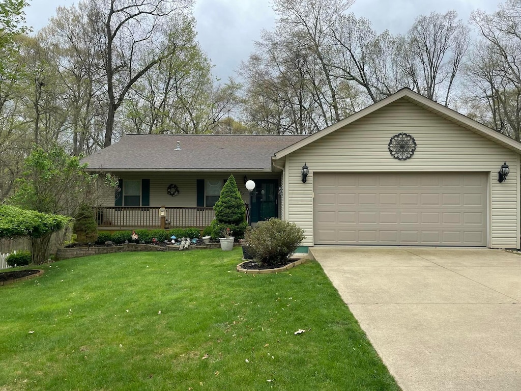 ranch-style home with a porch, a front lawn, driveway, and an attached garage