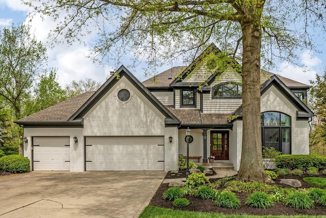 view of front of property featuring concrete driveway, brick siding, an attached garage, and a shingled roof